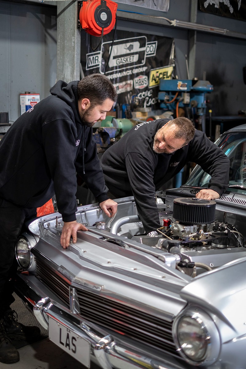 Jaiden (left) and Jason (right) working on the classic Holden EH Special.