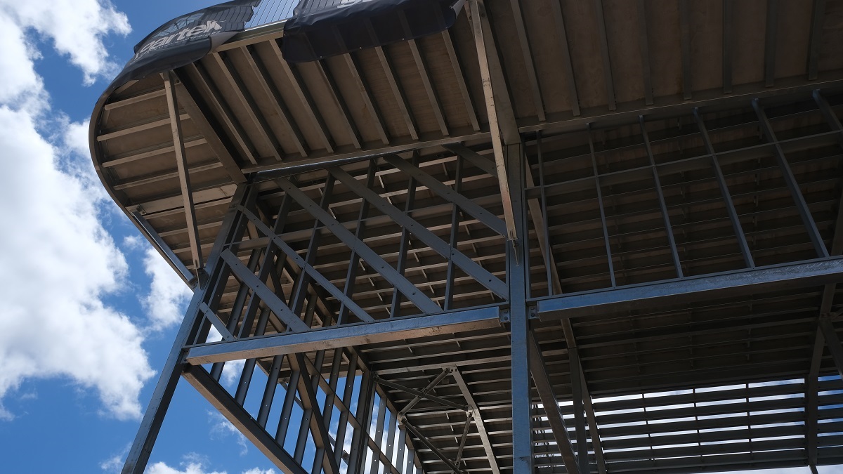Looking up at the metal frames of the race platforms under construction.