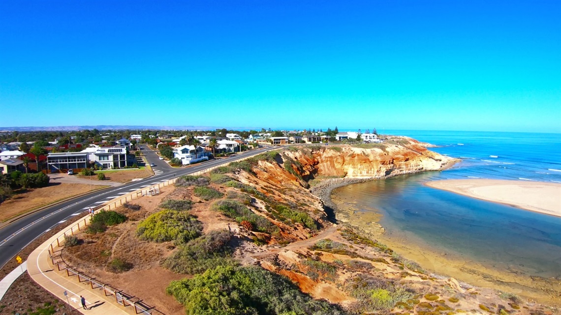 An aerial view of the coastline at Port Noarlunga South, overlooking the mouth of the Onkaparinga River.