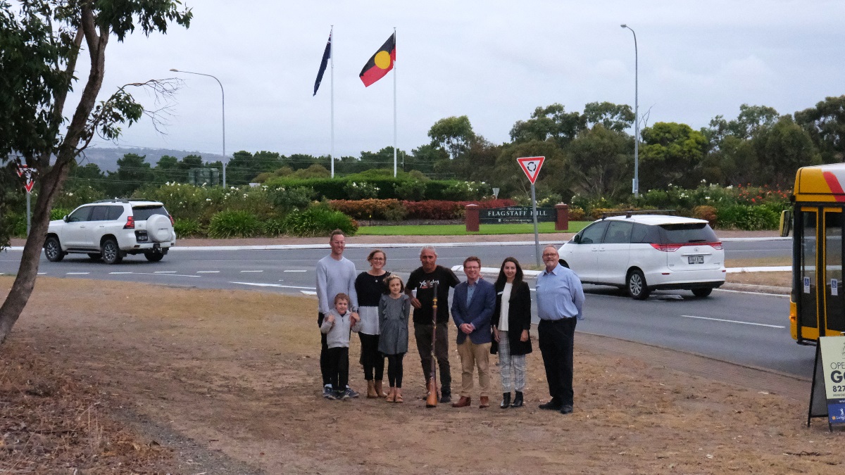 Summer and her family, Karl Telfer and elected members in front of the Flagstaff Hill roundabout.
