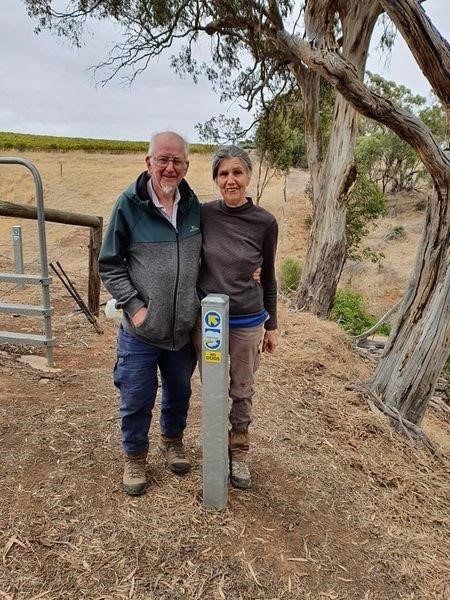 Chris Davies and Zara Lupton stand alongside the final post installed along the trail.