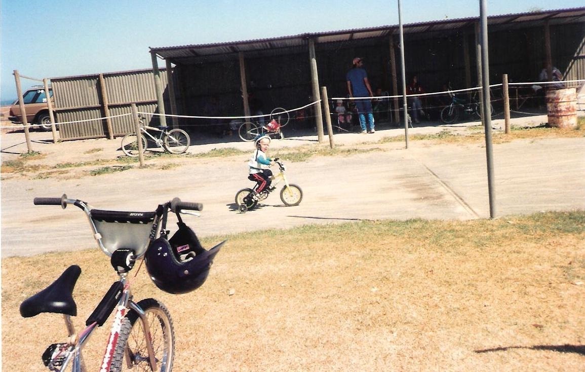 Sam Willoughby riding a bike on a track as a toddler.