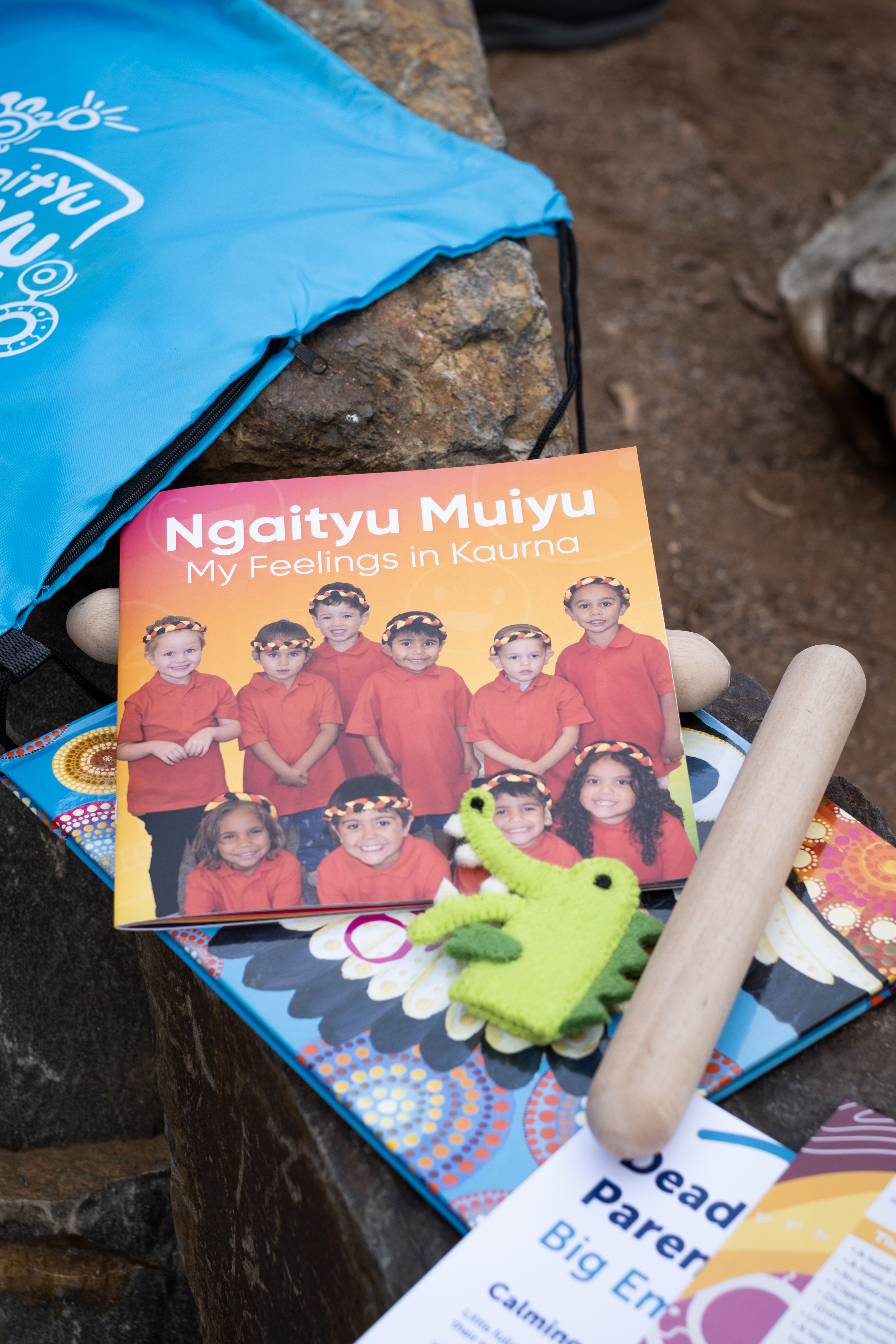 Photo of backpack contents including books and finger puppet