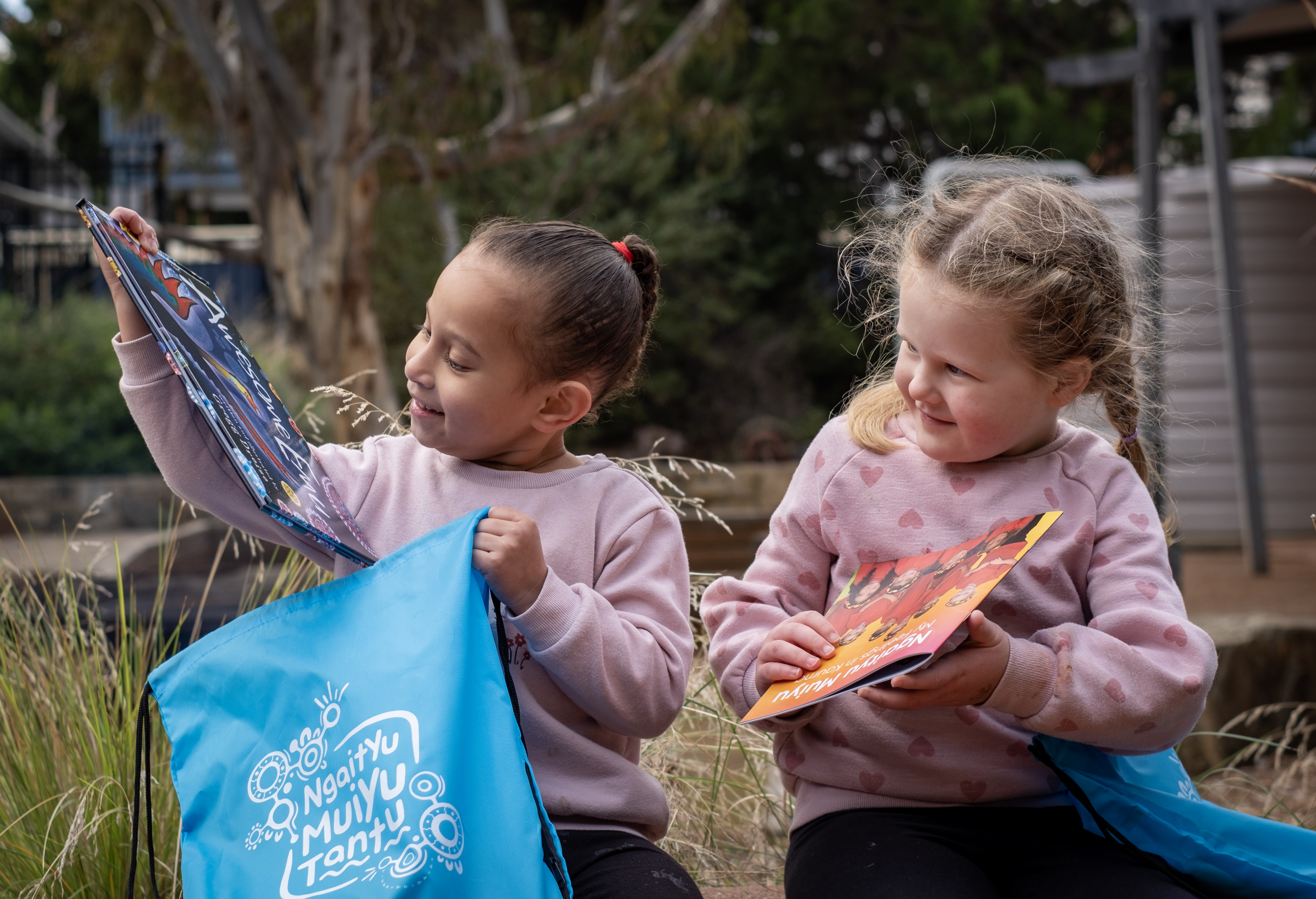 Photo of Poppie and Lylah exploring their backpacks