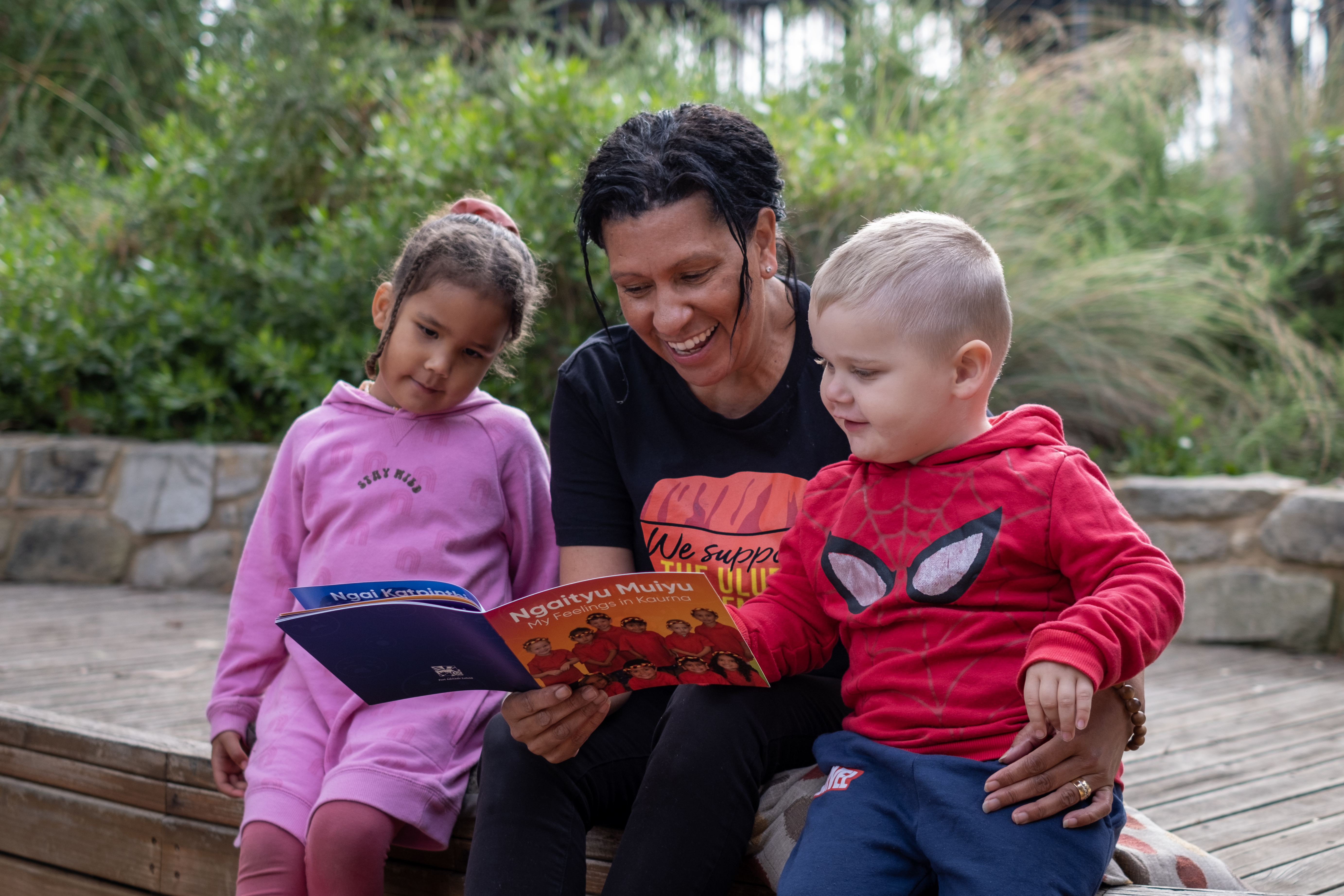 Photo of children having the book read to them