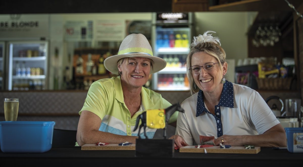 Kath Layton and Heather Zinnoegger support the club’s annual Melbourne Cup community fundraiser.