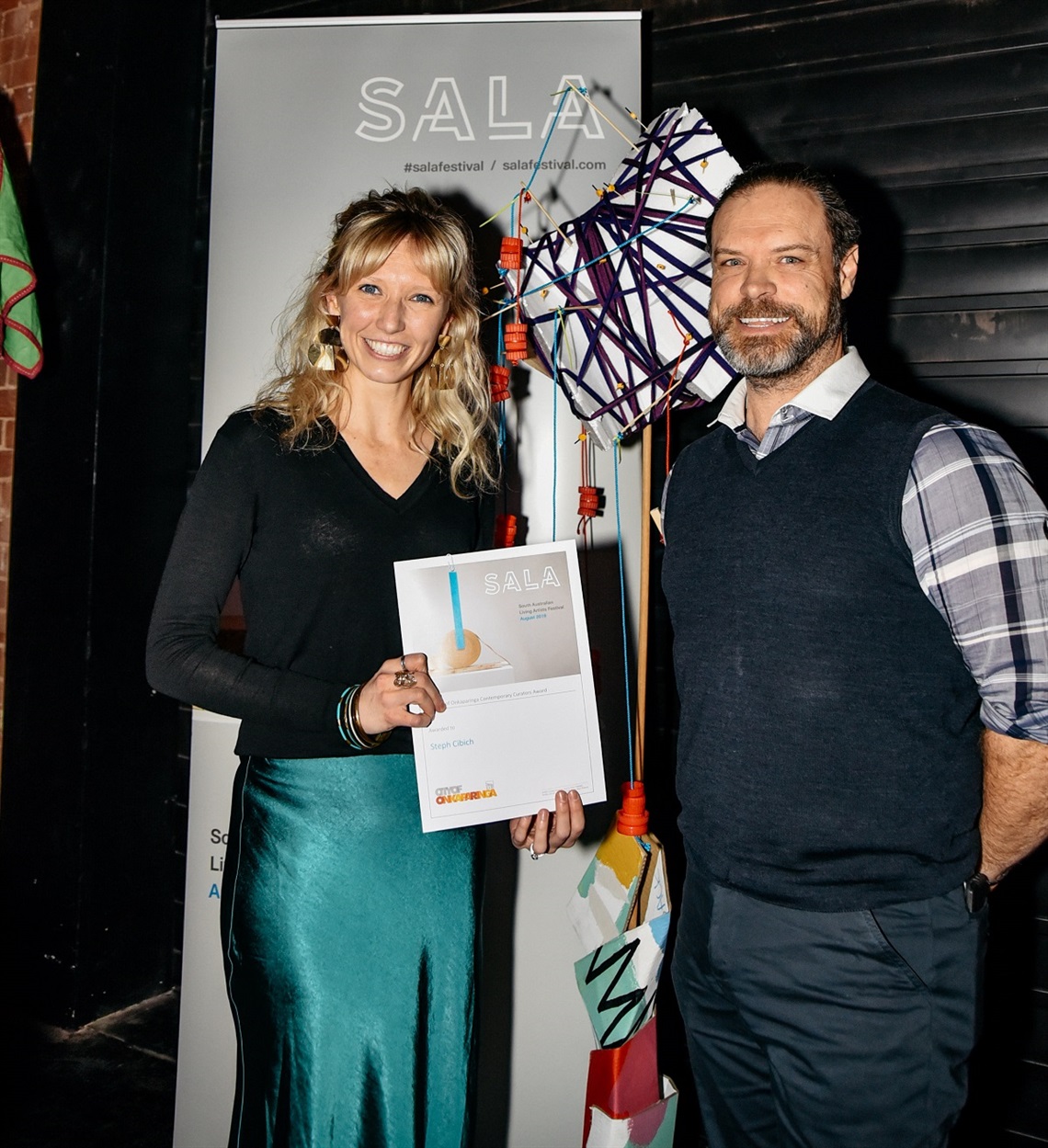 Steph receiving her award from City of Onkaparinga Team Leader, Arts and Events, Jason Haskett. Photo: SALA/Jack Fenby