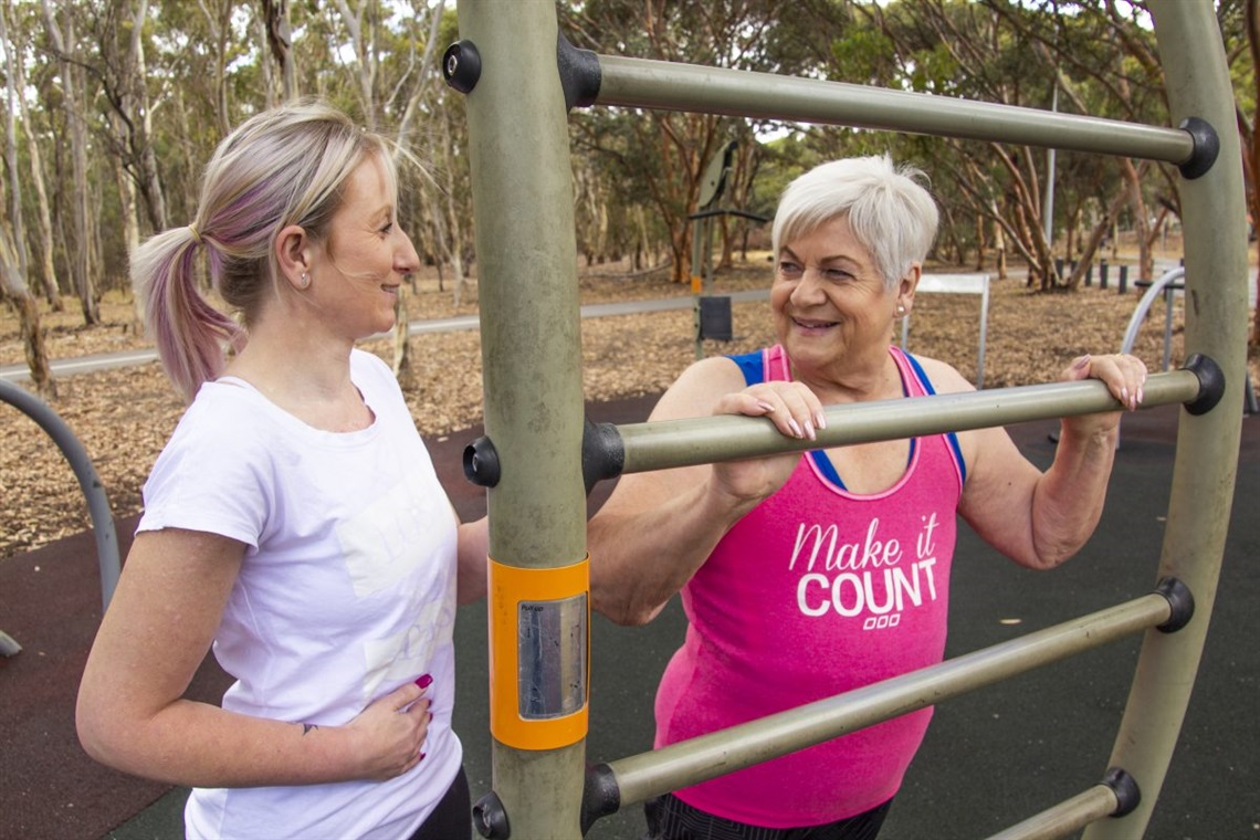 Resident Vinetta working through a range of exercises and stretches under the watchful eye of trainer, Nicola, at Minkarra Park in Aberfoyle Park.