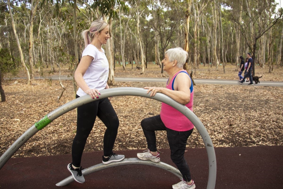 Resident Vinetta working through a range of exercises and stretches under the watchful eye of trainer, Nicola, at Minkarra Park in Aberfoyle Park.