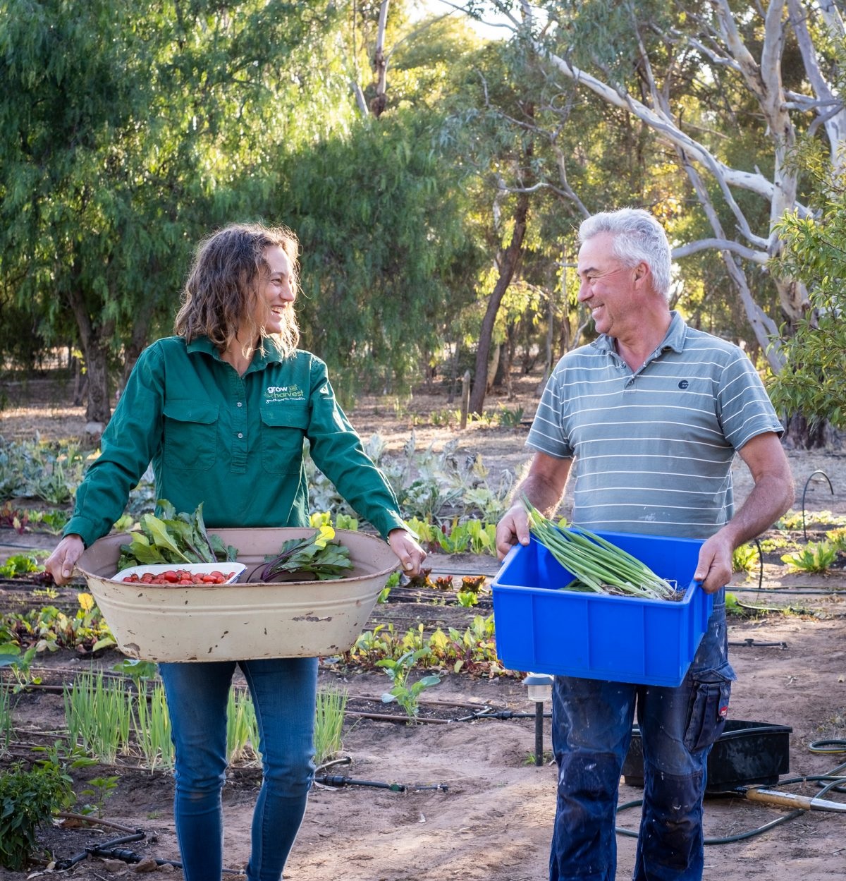 Bec Walker and John Walker enjoy their harvest of healthy food; volunteers help with the many activities that need to be done in the garden.