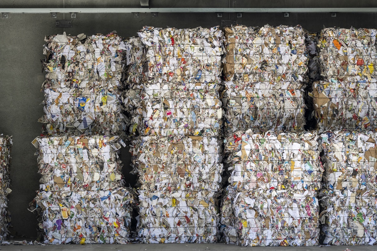 Recycled paper and cardboard in stacked bales at the new facility.