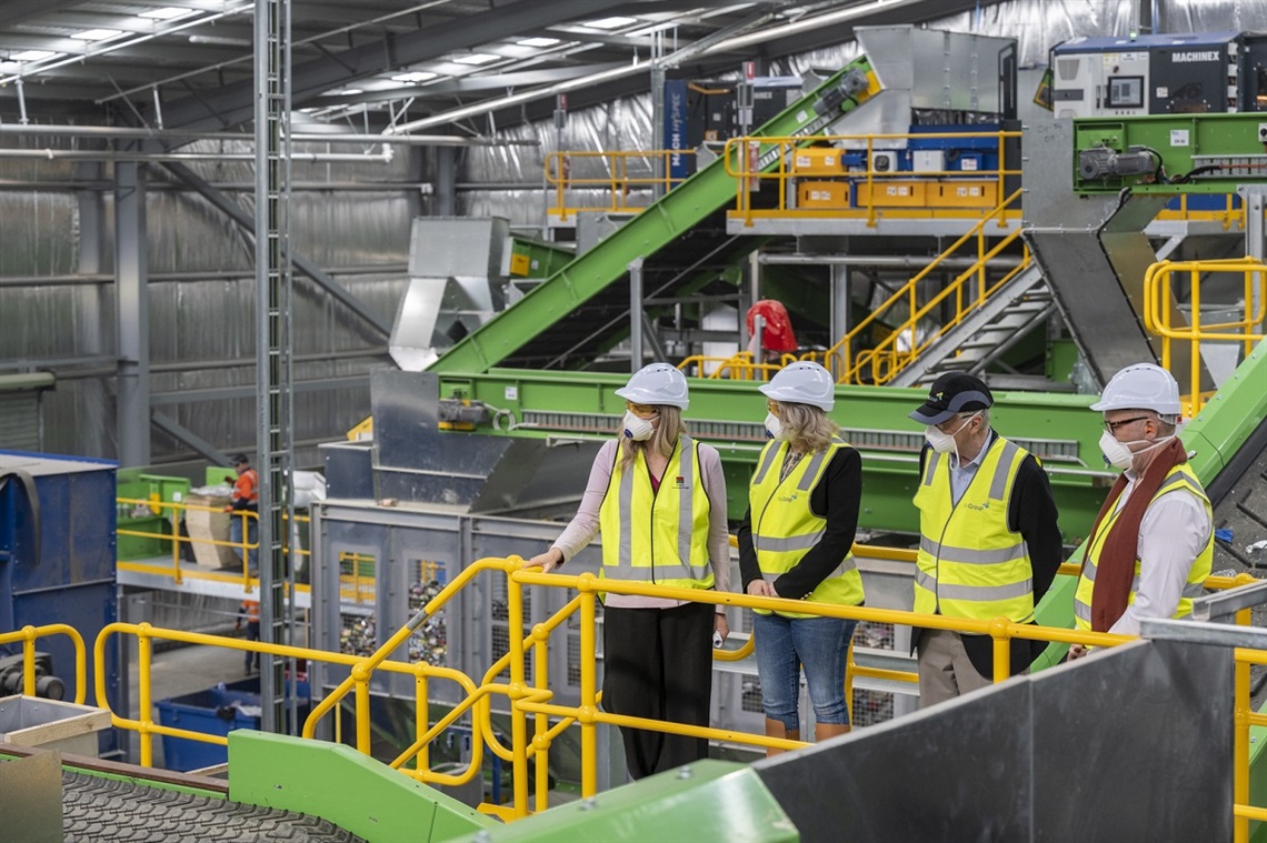 The mayors of Onkaparinga, Marion and Holdfast Bay look across at the new recycling facility's high-tech macinery.