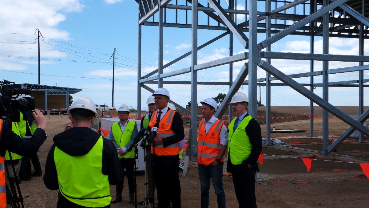 Politicians gather in high vis vests and helmets to announce the test run.