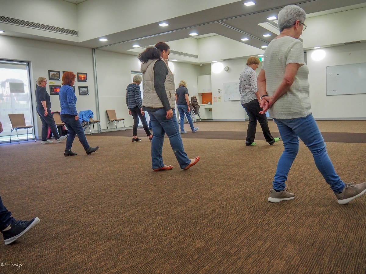 A group of line dancing participants do their moves in time at the centre.