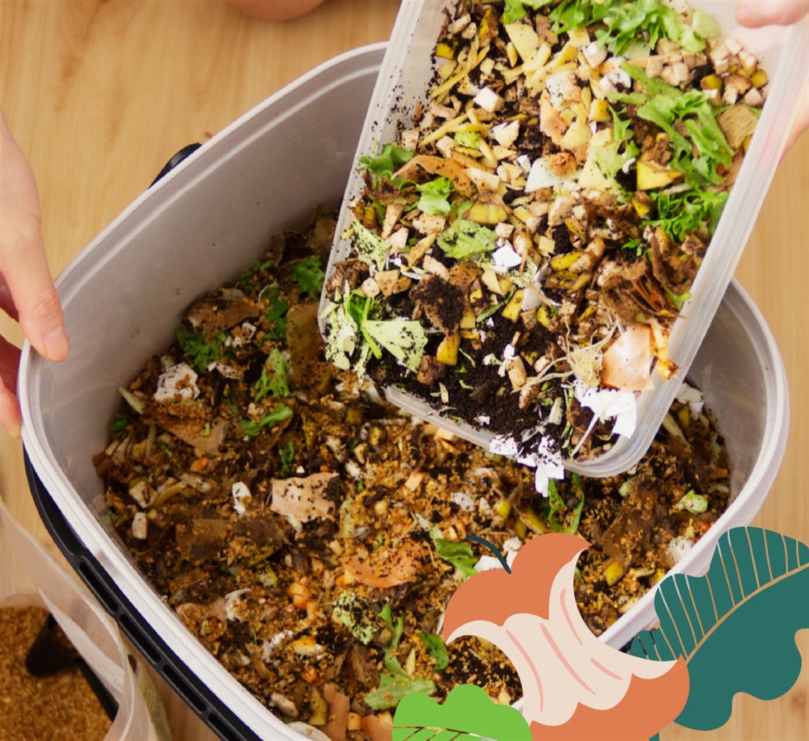 A person holding a container of food scraps for a bokashi bin.