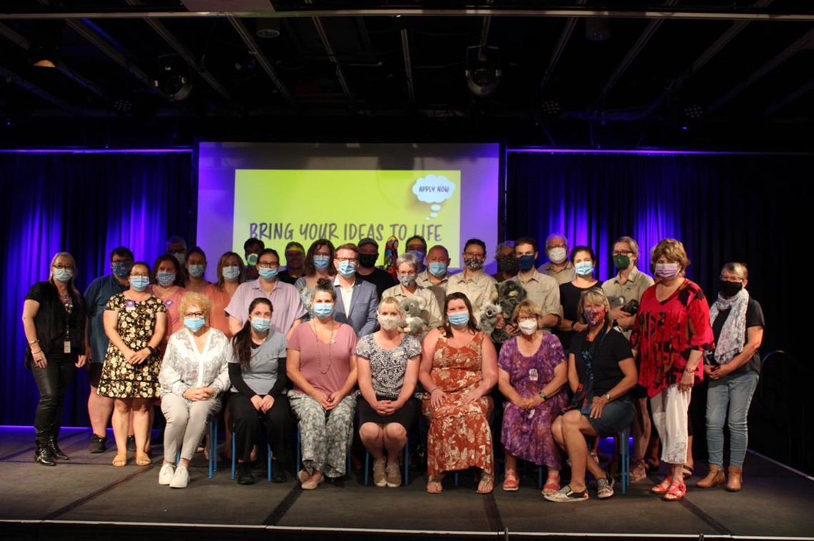 Community grants recipients standing together on stage at the Arts Centre for the pitch night.