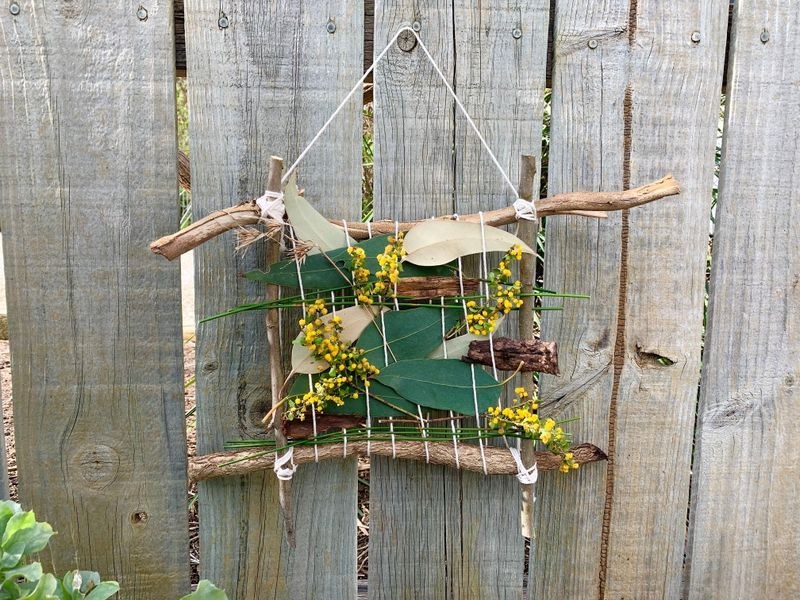 A wall hanging made of native plants.