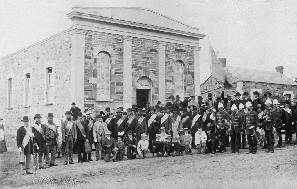 A black-and-white image of dozens of people in front of the 'Oddfellows Hall' in Willunga for its opening event at 35 High Street Willunga, circa 1890.