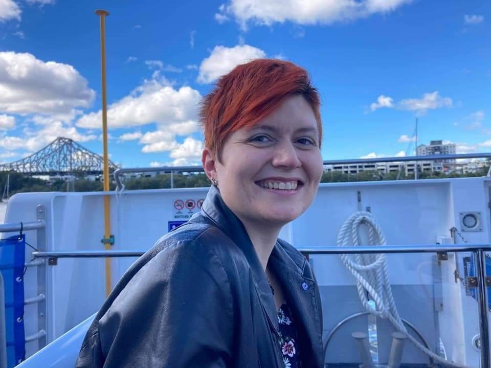 Season smiles on holiday with a city skyline behind her.