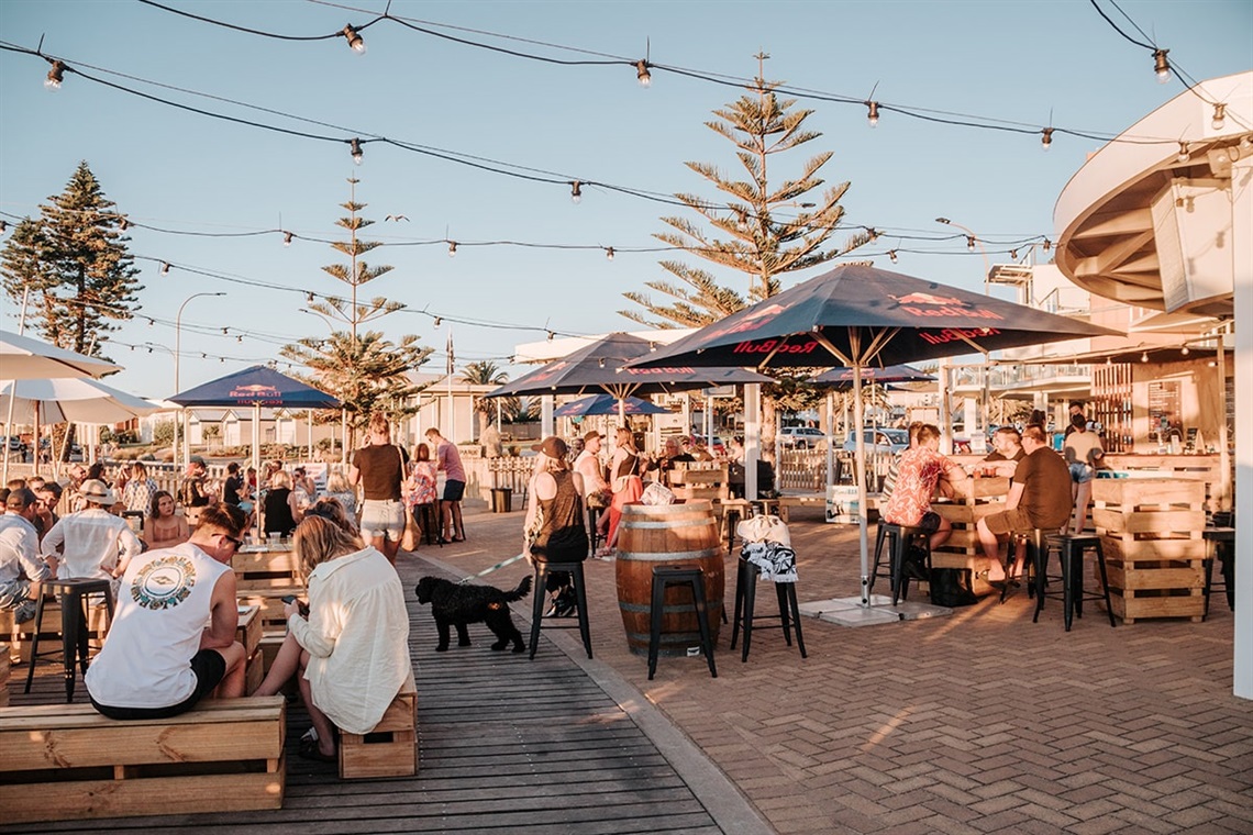 People drinking and eating at the foreshore SandBAR at Christies Beach.