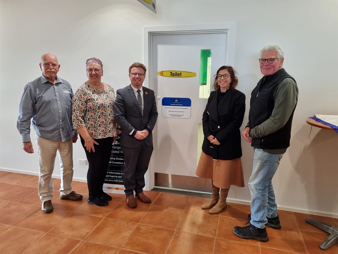 South Port Surf Life Saving's Dick Olesinski, Cr Sue Tonkin, Acting Mayor Simon McMahon, Amanda Rishworth MP and Cr Bill Jamieson stand at the entrance to the revamped changerooms at South Port Surf Life Saving Club.