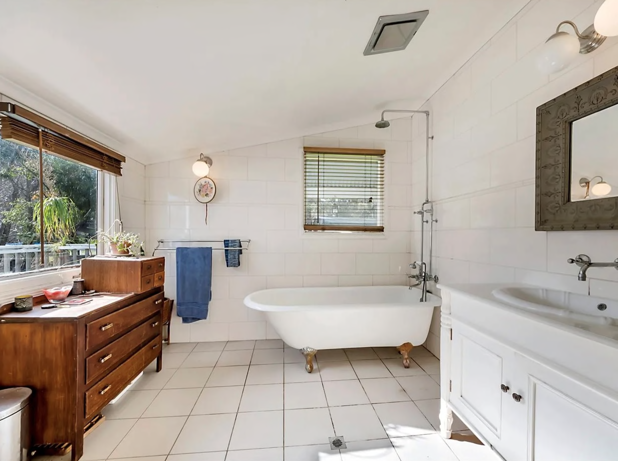 A photo of the light-filled white bathroom at 85 St Johns Terrace, Willunga.