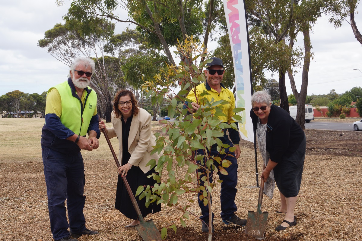 Council horticulture staff smile with Amanda Rishworth MP and Mayor Moira Were as they plant a tree at Morphett Vale's Knox Park.