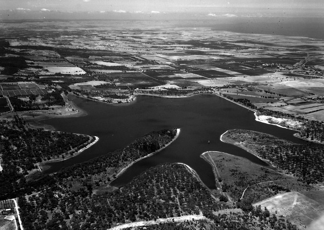 A black-and-white aerial image of the Happy Valley Reservoir circa 1950s.
