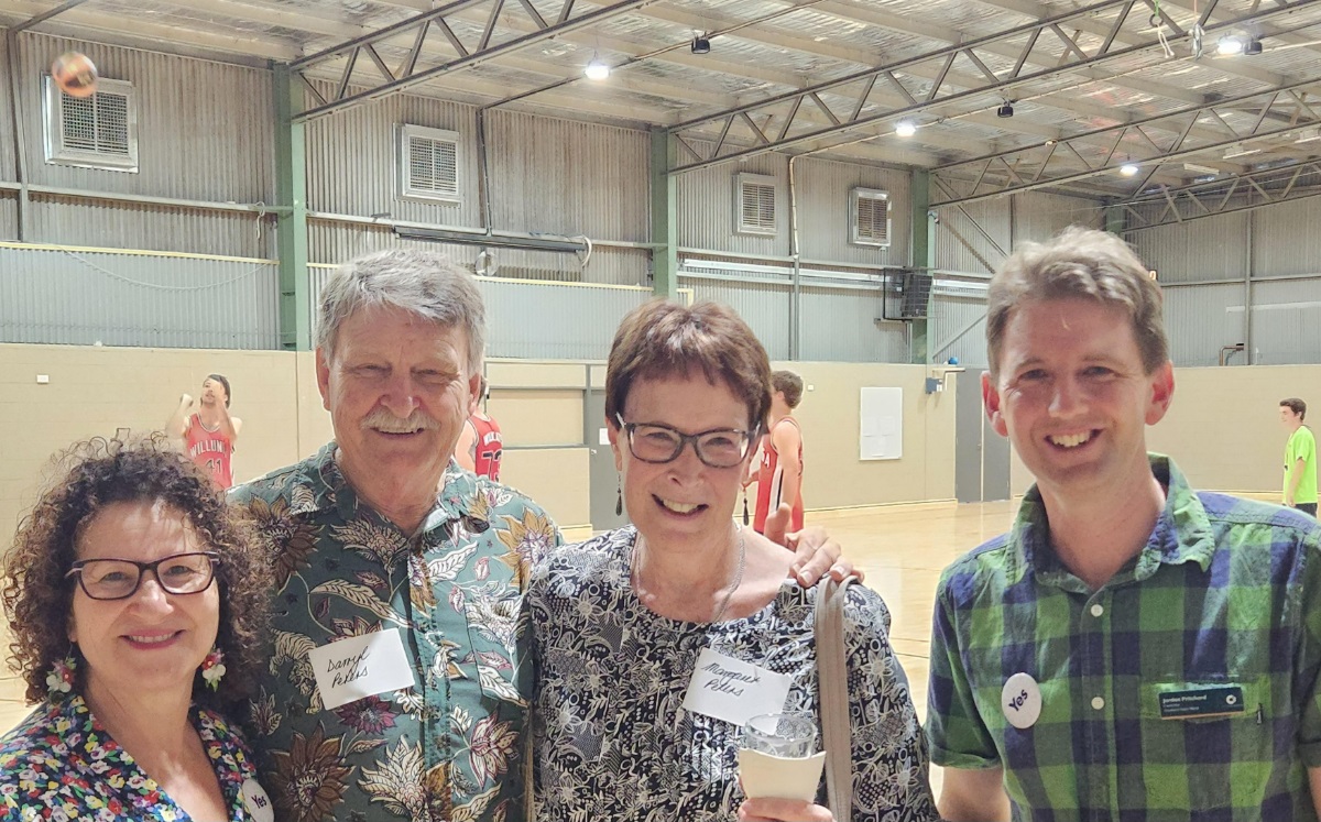 Councillors Marisa Bell and Jordan Pritchard smile alongside two constituents in a sporting hall.
