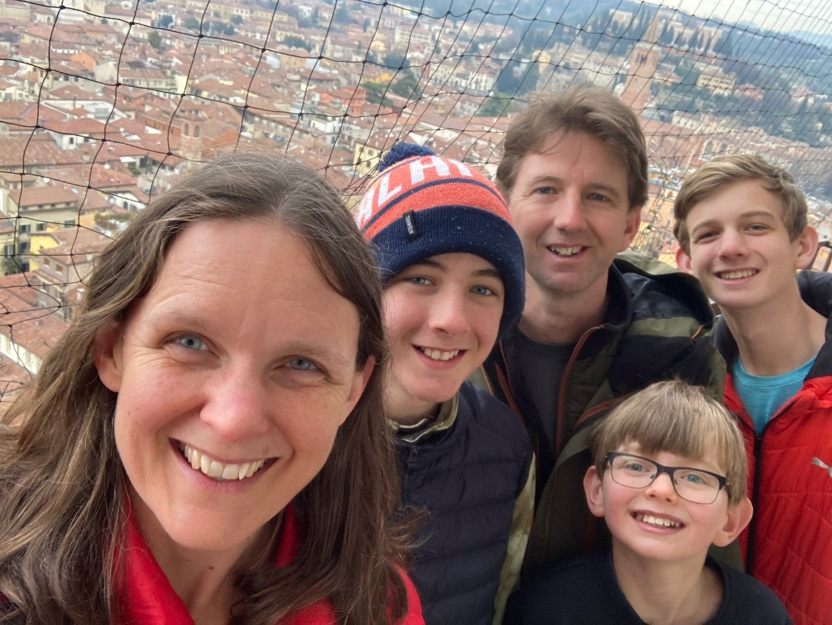 Councillor Jordan Pritchard, his wife and three sons smile and take a selfie from a great height with a city in the background below.