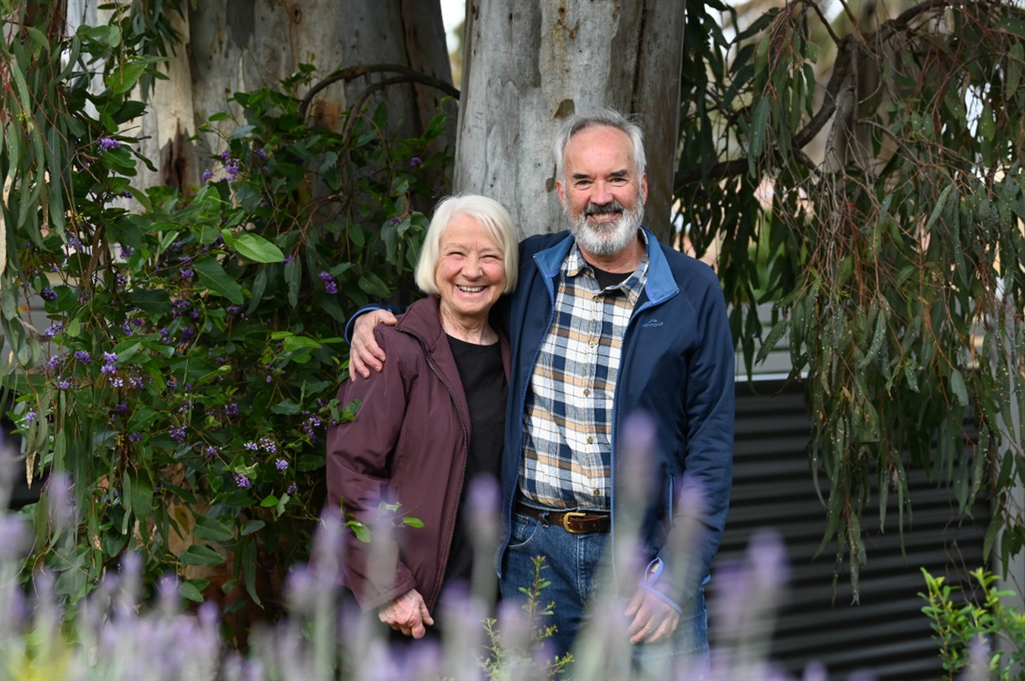 A photo of Ian Fox and Trish Hammond smiling alongside their huge Aberfoyle Park tree.