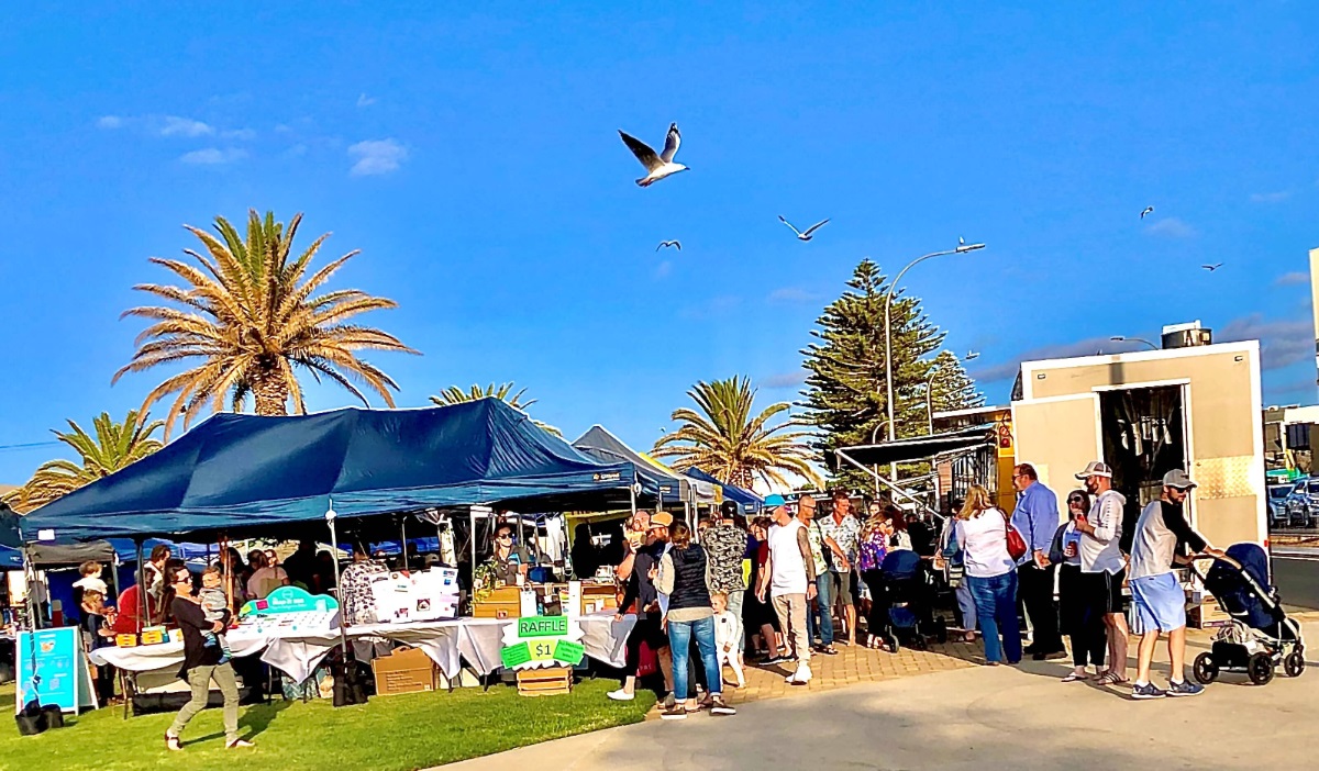 Crowds of people at a market at Christies Beach's Rotary Park.