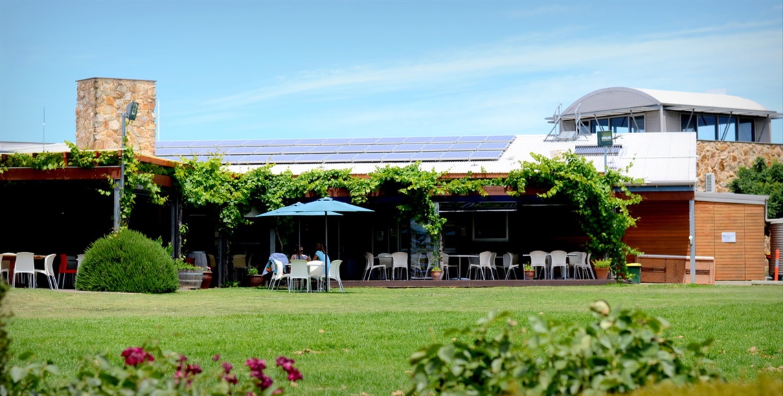 A photo of the McLaren Vale and Fleurieu Coast Visitor Centre from afar, showing solar panels on its roof.