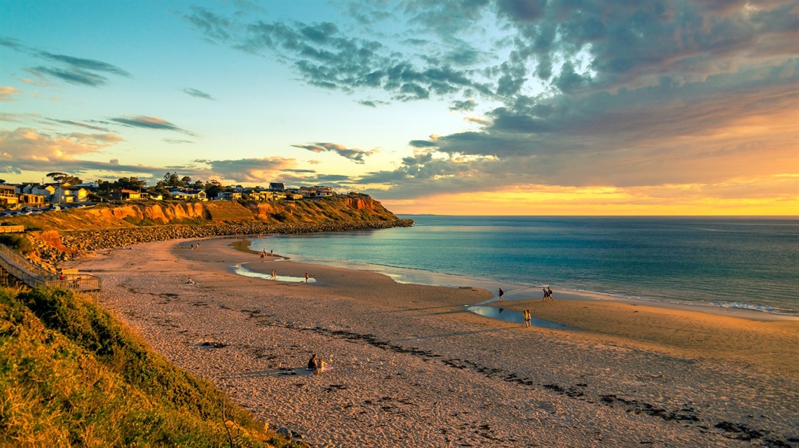 A late-afternoon view of Witton Bluff from Christies Beach, with the cliffs bathed in golden sunlight.