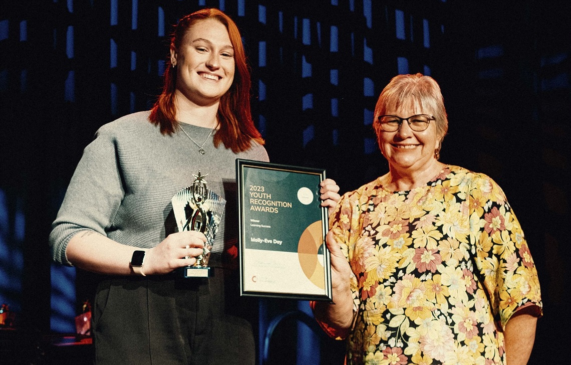 Learning Success Award recipient Molly Eve-Day smiles on stage alongside Onkaparinga Mayor Moira Were.
