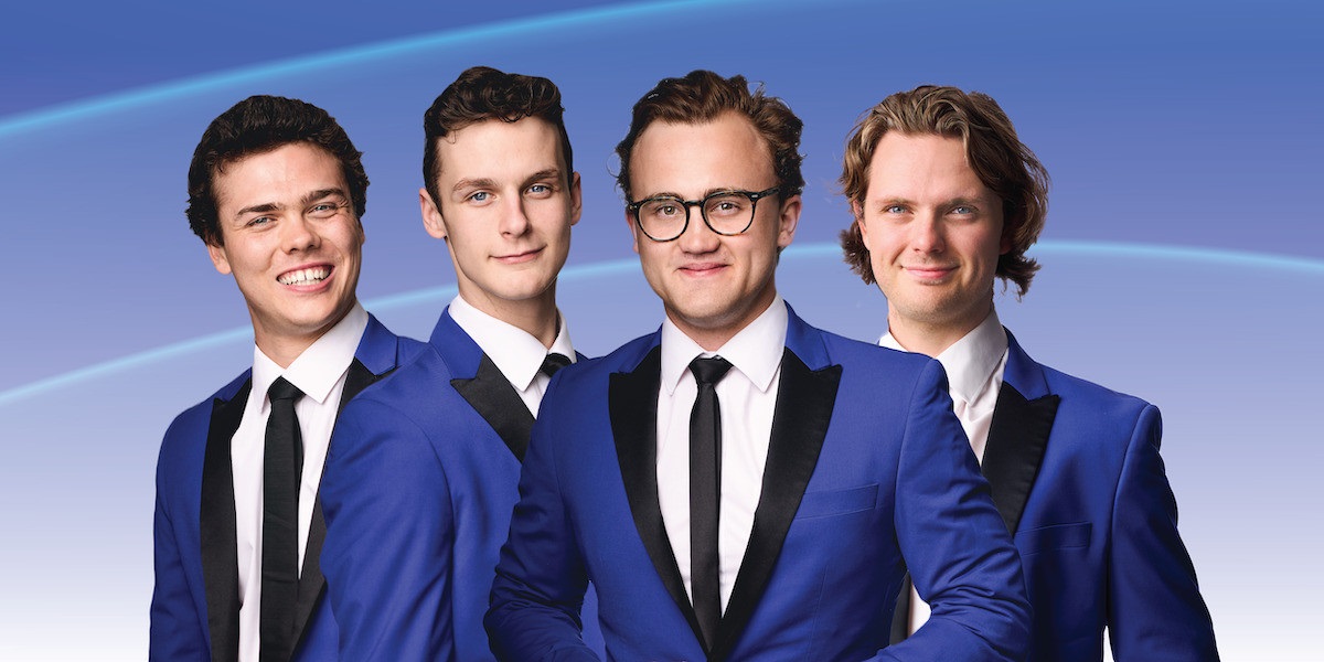 The four members of tribute act The 60 Four wearing blue suits.