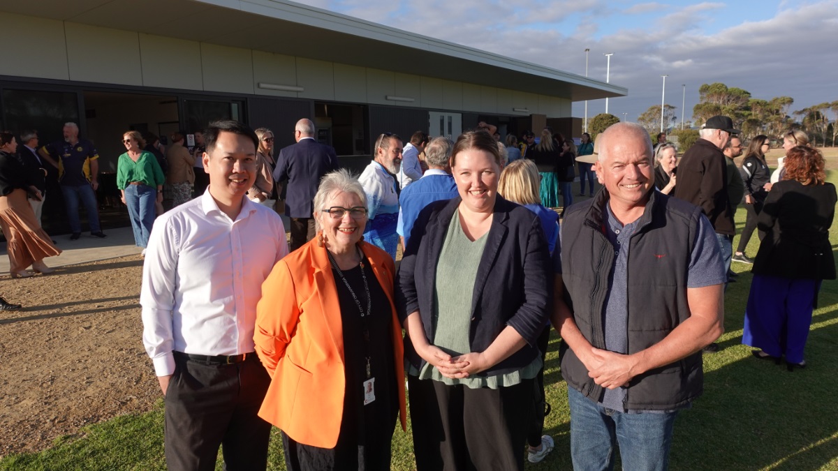 City of Onkaparinga's CEO, mayor and South Coast councillors smile in front of the new Aldinga Sports Park soccer clubroom.