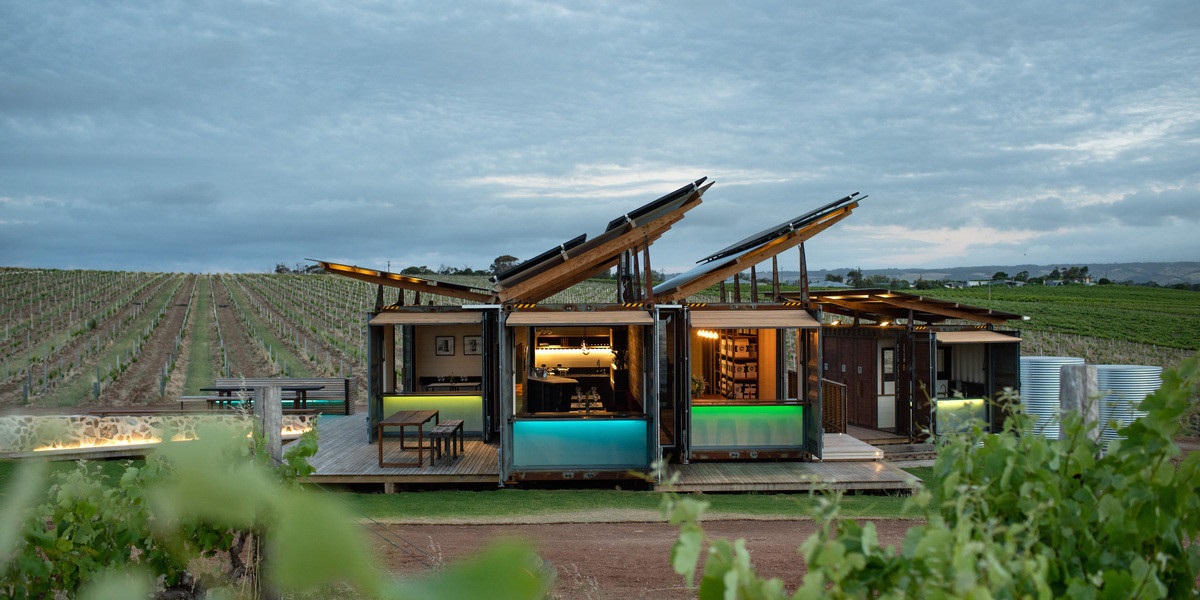 The Dowie Doole winery, consisting of fitted-out shipping containers surrounded by vineyards and an overcast sky.