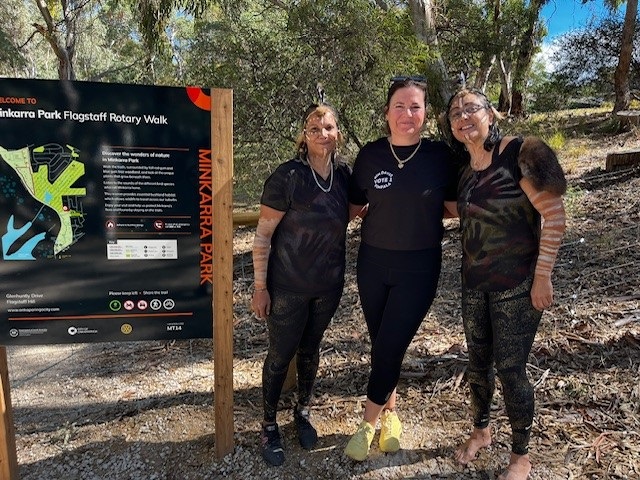 Councillor Kim Davis with Naomi and Maureen from Spirit in Unity alongside a trail sign at Minkarra Park, Flagstaff Hill.