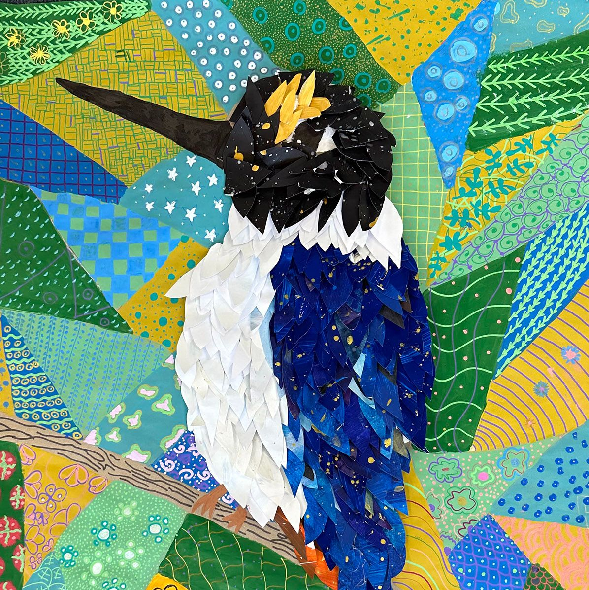 A mixed media image of a Sacred Kingfisher by Riley and Autumn from All Saints Catholic Primary School.