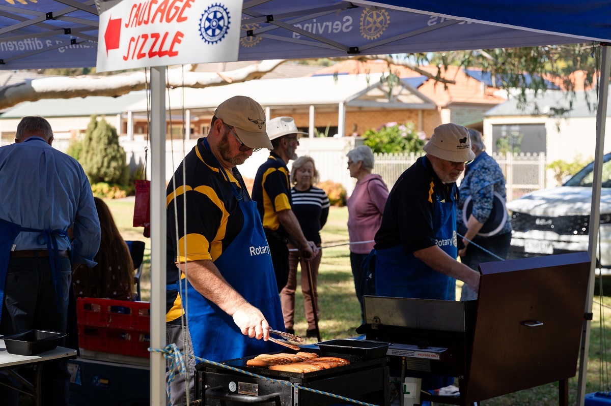 Rotary Club members cook a barbecue for the community in attendance during the Minkarra Park Link Path opening.