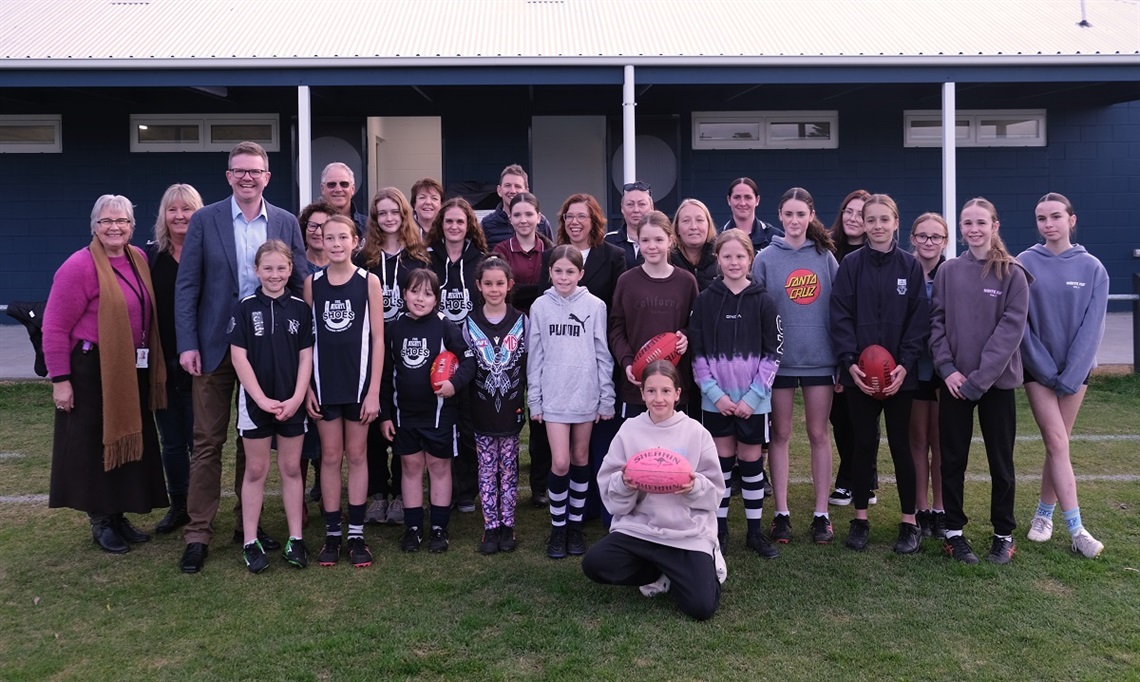 Players, politicians and elected members stand in front of the Old Noarlunga change rooms.