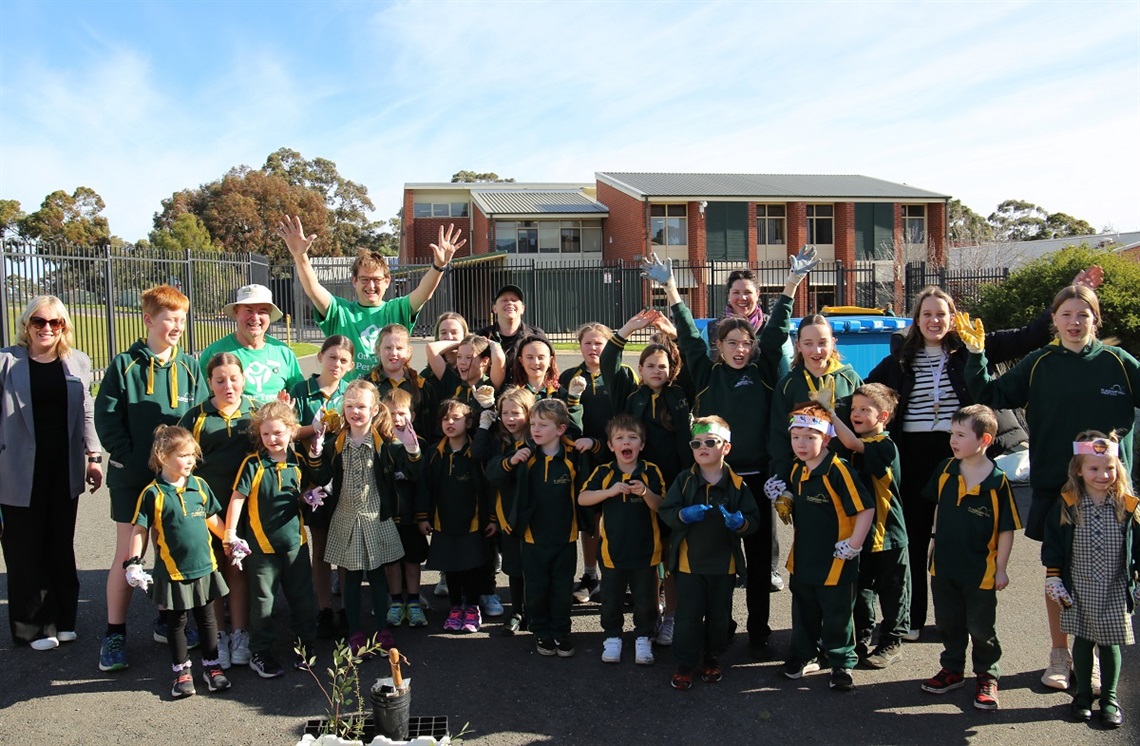 Students from Flagstaff Hill Primary School huddle for a photo following their tree planting.