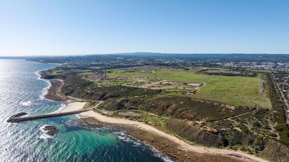 An aerial photograph showing the coast of Port Stanvac as it looks now, with hectares of green open space.