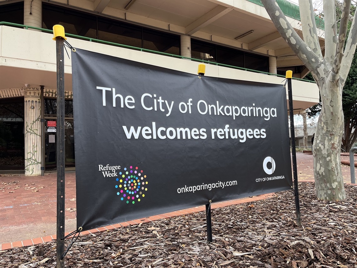 A black banner with the words 'The City of Onkaparinga welcomes refugees'.