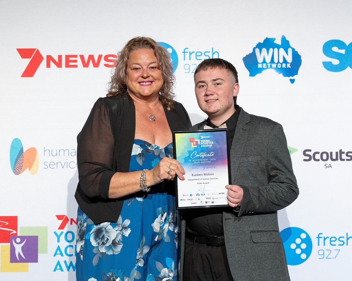 Minister for Human Services, Nat Cook MP, presents Reuben Watson with his semi-finalist Department of Human Services Pride Award.