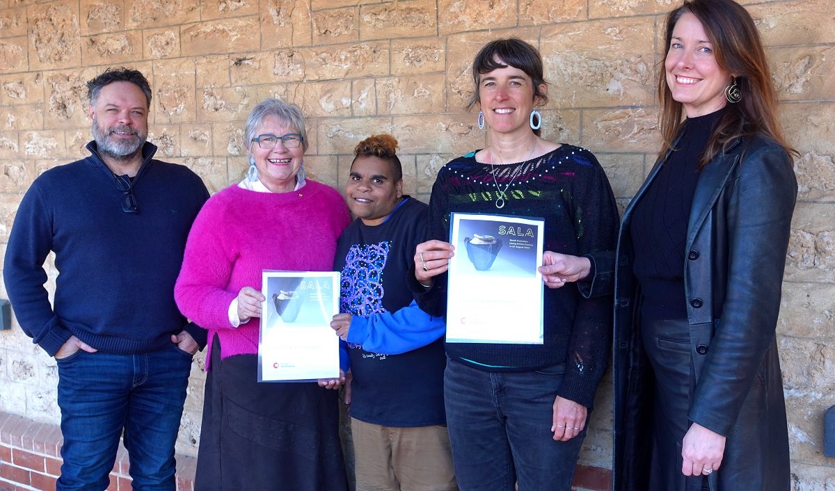 City of Onkaparinga's Jason Haskett and Moira Were, artists Jackie Saunders and Laura Wills, and SALA CEO Bridget Alfred smile alongside the wall of Sauerbier House.