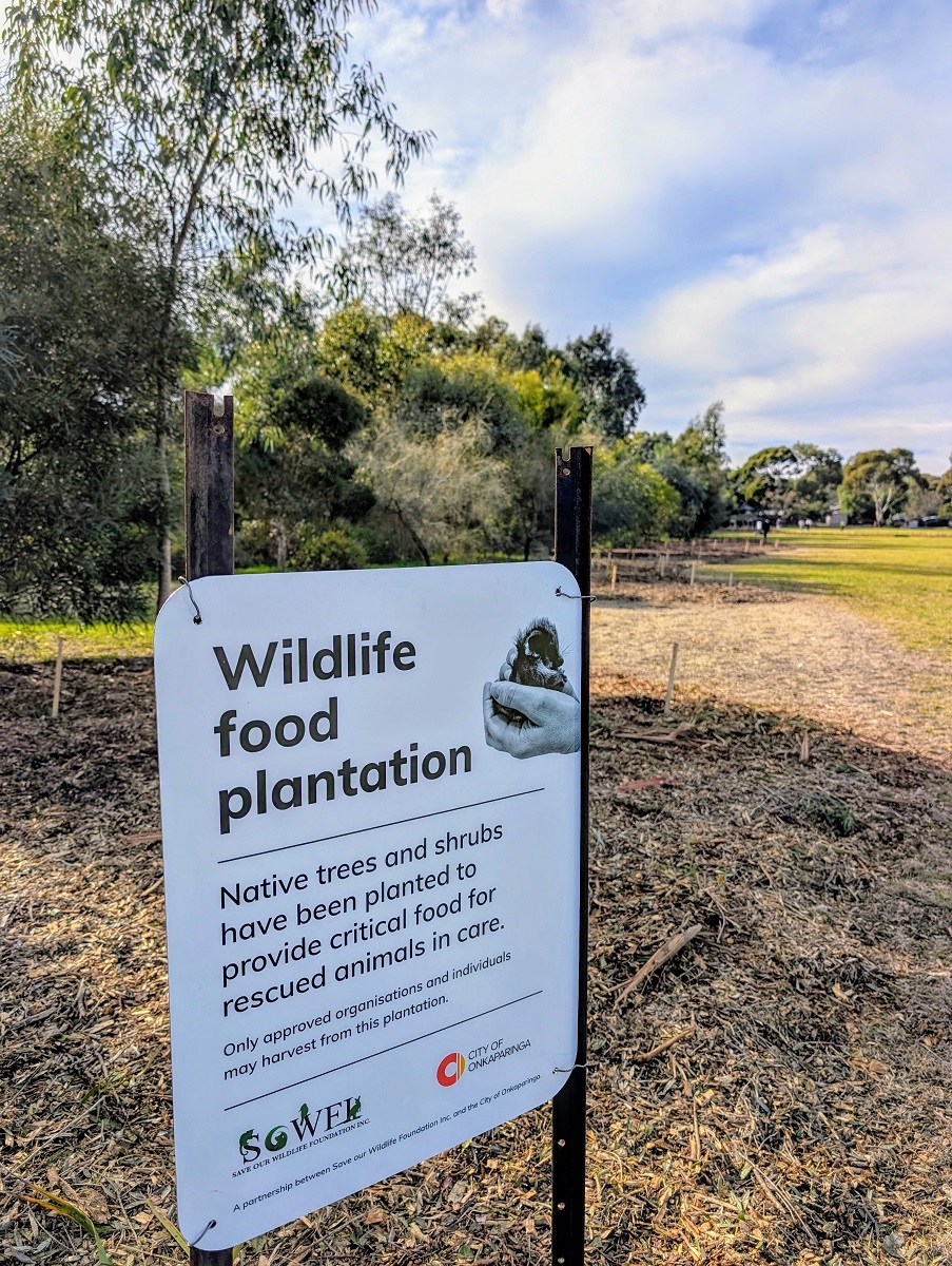A photo of a 'Wildlife food plantation' sign in a garden bed at a Happy Valley reserve.