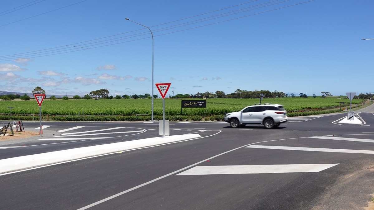 A view from the intersection of Main Road, Johnston Road and McMurtrie Road as a car zooms along Main Road.