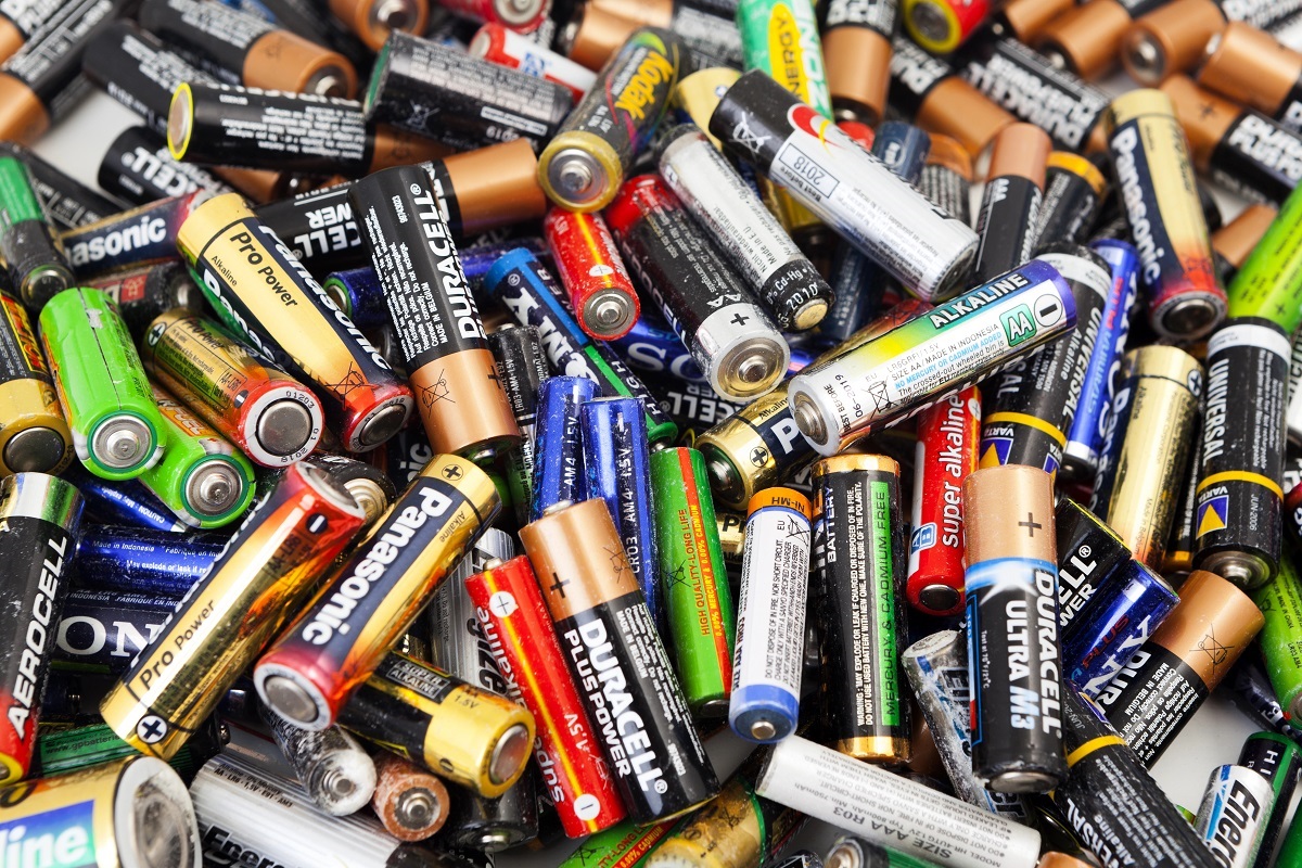 A close-up photo of a pile of mixed use batteries of various colours, brands and sizes.